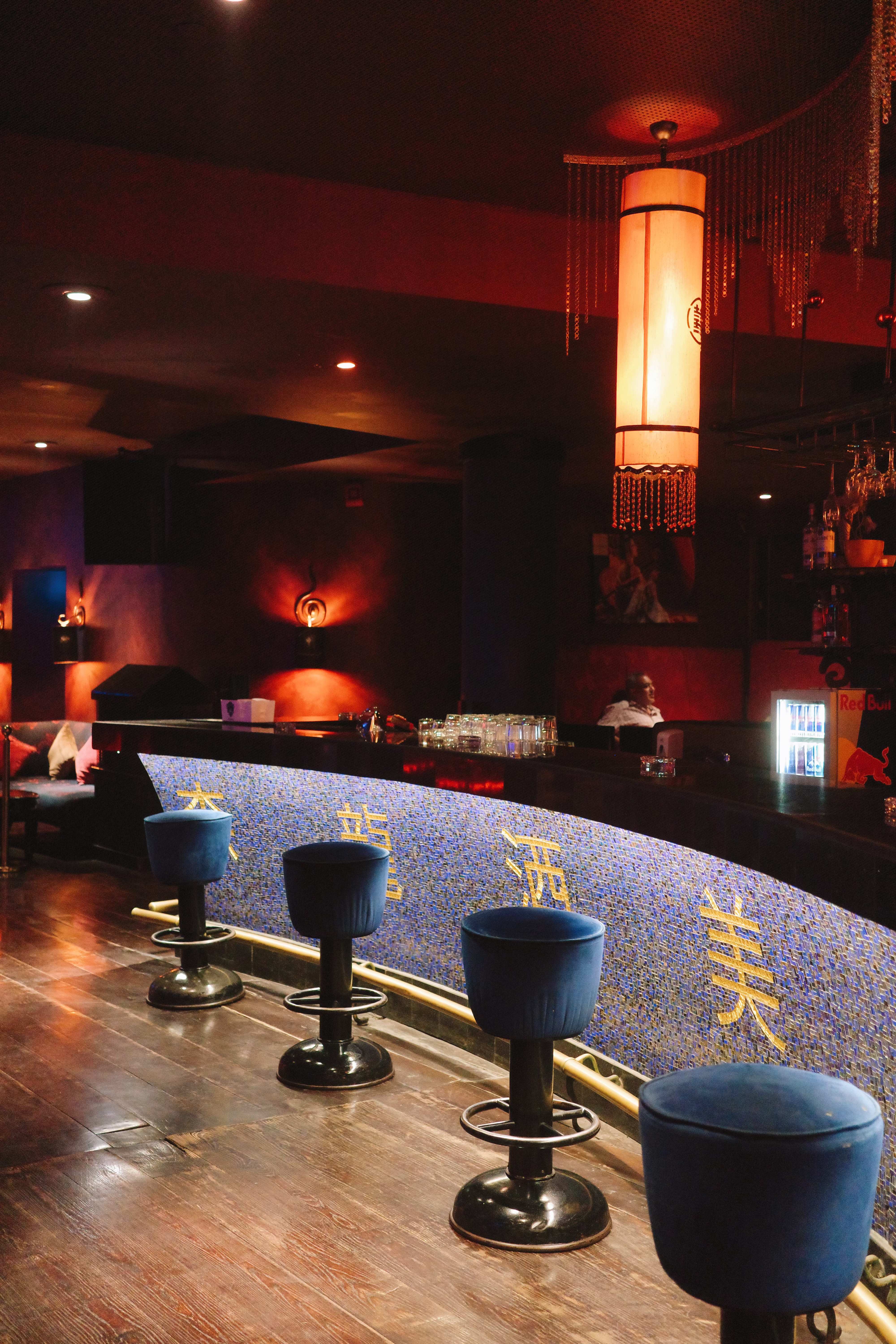 Buddha Bar counter with blue mosaic detail and bar stools