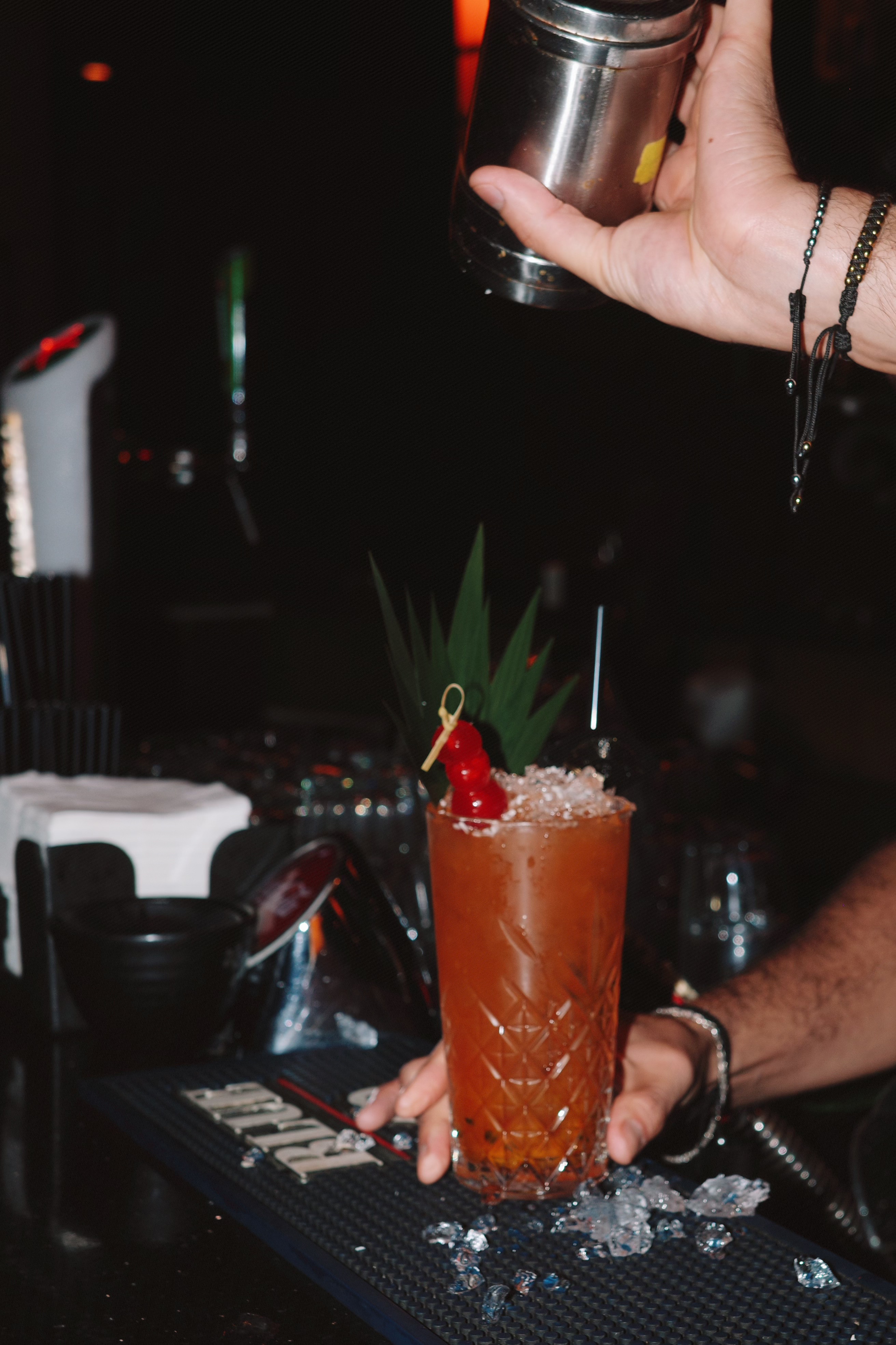Tropical cocktail preparation with exotic garnishes
