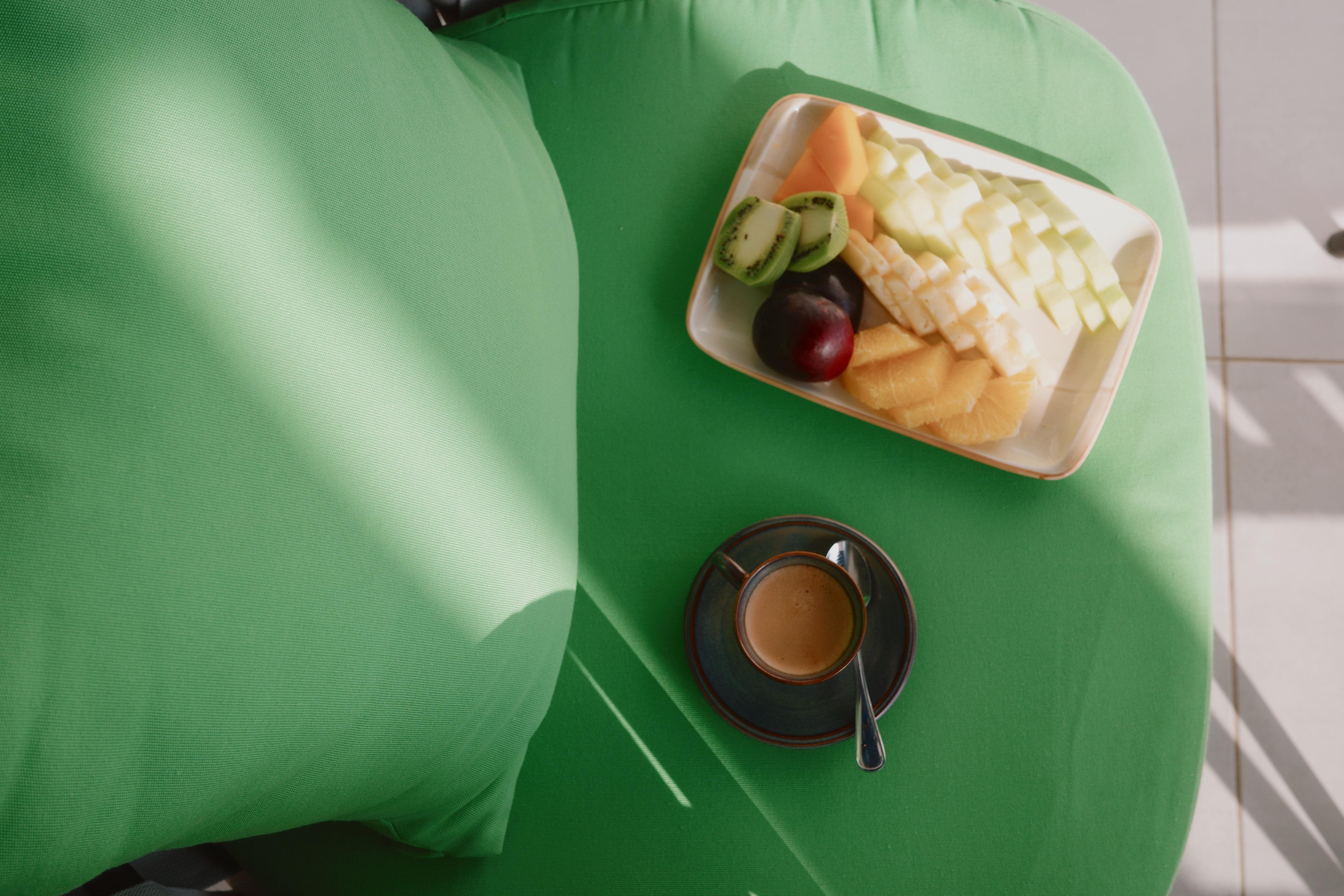 Breakfast detail on balcony with coffee and fruit