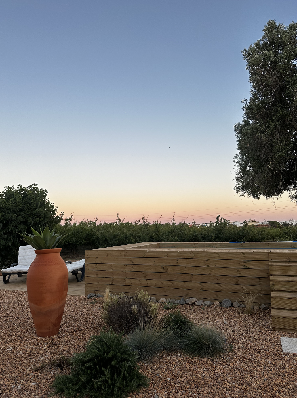Outdoor relaxation area with hot tub at sunset